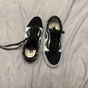 Women’s black and white Vans sneakers